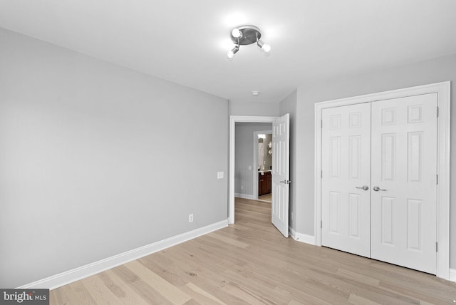 41311 Silverside Dr, Leesburg, VA 20175 - unfurnished bedroom featuring baseboards, light wood finished floors, and a closet