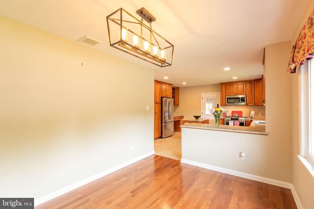 724 E Curtin St, Bellefonte, PA 16823 - kitchen featuring stainless steel appliances, brown cabinetry, recessed lighting, light wood-type flooring, and baseboards
