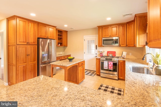 724 E Curtin St, Bellefonte, PA 16823 - kitchen featuring stainless steel appliances, a sink, brown cabinets, light stone counters, and recessed lighting
