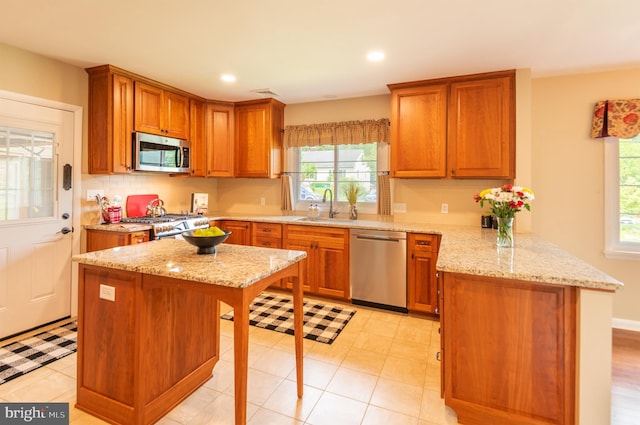 724 E Curtin St, Bellefonte, PA 16823 - kitchen featuring stainless steel appliances, a peninsula, a sink, brown cabinets, and recessed lighting