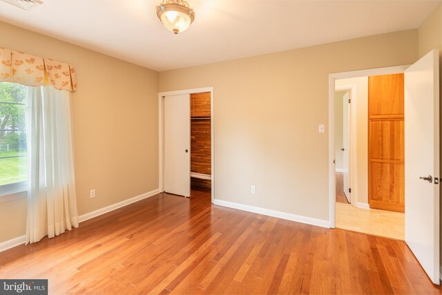 724 E Curtin St, Bellefonte, PA 16823 - unfurnished bedroom featuring light wood-type flooring, baseboards, and a closet