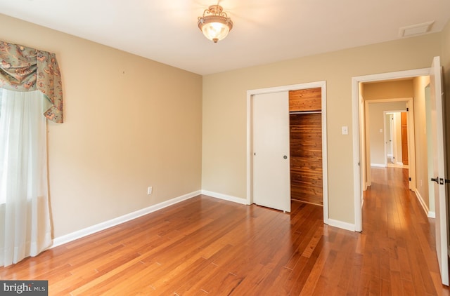 724 E Curtin St, Bellefonte, PA 16823 - unfurnished bedroom featuring wood finished floors, baseboards, and a closet