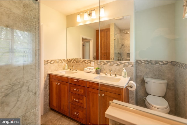724 E Curtin St, Bellefonte, PA 16823 - bathroom with tile walls, tile patterned flooring, double vanity, toilet, and a tile shower
