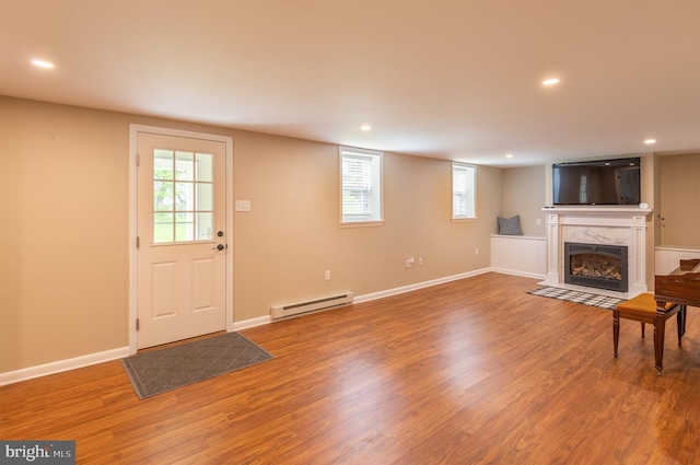 724 E Curtin St, Bellefonte, PA 16823 - unfurnished living room with a baseboard radiator, a high end fireplace, wood finished floors, recessed lighting, and baseboards