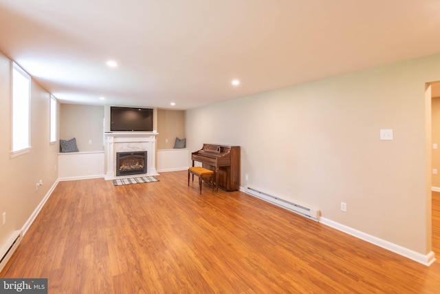 724 E Curtin St, Bellefonte, PA 16823 - living room featuring a baseboard radiator, wood finished floors, a premium fireplace, recessed lighting, and baseboards