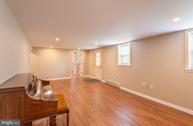 724 E Curtin St, Bellefonte, PA 16823 - unfurnished living room with a baseboard heating unit, recessed lighting, light wood-type flooring, and baseboards