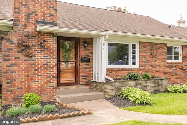 724 E Curtin St, Bellefonte, PA 16823 - entrance to property featuring brick siding, roof with shingles, and a chimney