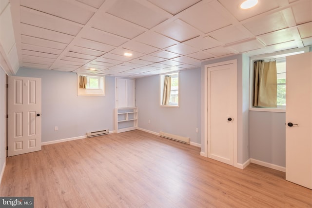 724 E Curtin St, Bellefonte, PA 16823 - below grade area with a baseboard heating unit, baseboard heating, light wood finished floors, and healthy amount of natural light