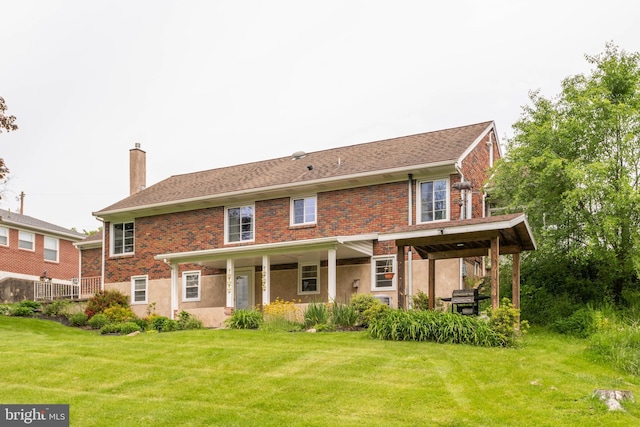 724 E Curtin St, Bellefonte, PA 16823 - back of house with a chimney, a lawn, and brick siding