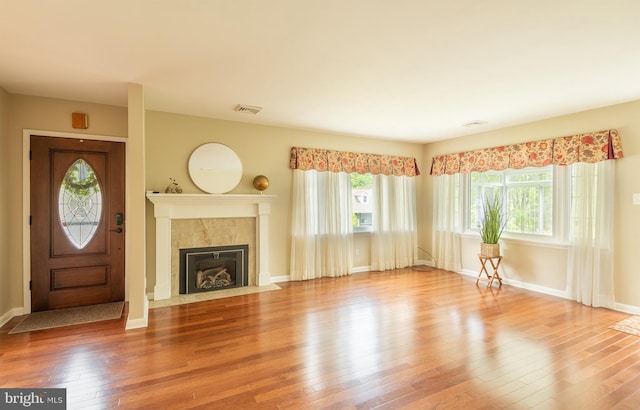 724 E Curtin St, Bellefonte, PA 16823 - unfurnished living room featuring a fireplace, wood finished floors, and baseboards