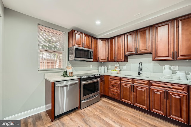 1402 W Lombard St, Baltimore, MD 21223 - kitchen featuring stainless steel appliances, a sink, light countertops, light wood finished floors, and recessed lighting