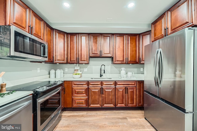 1402 W Lombard St, Baltimore, MD 21223 - kitchen with appliances with stainless steel finishes, a sink, light countertops, light wood-style flooring, and recessed lighting