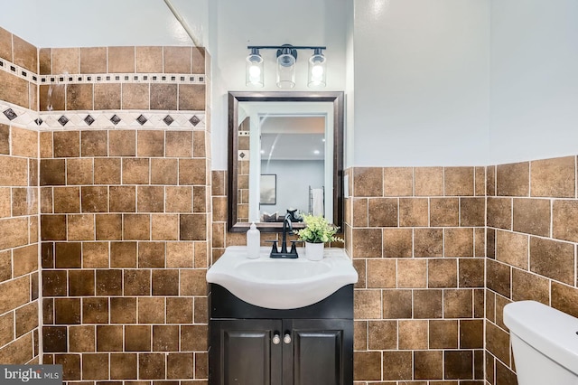 1402 W Lombard St, Baltimore, MD 21223 - bathroom with tile walls, vanity, and toilet