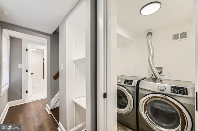 1402 W Lombard St, Baltimore, MD 21223 - laundry room with separate washer and dryer, dark wood-type flooring, and baseboards