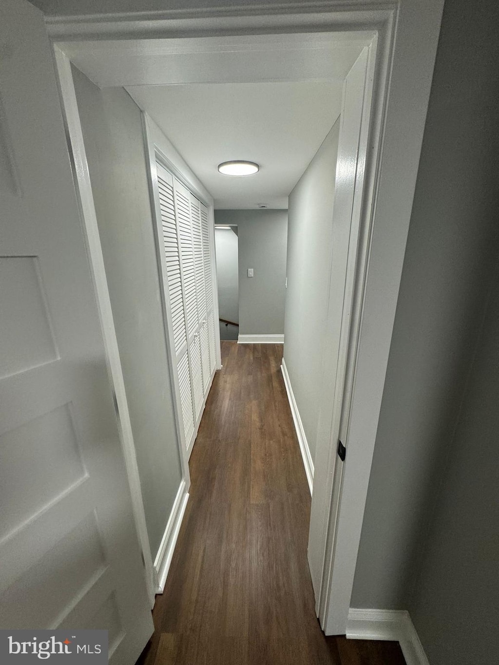 1402 W Lombard St, Baltimore, MD 21223 - hallway featuring dark wood finished floors and baseboards