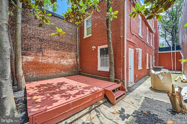 1402 W Lombard St, Baltimore, MD 21223 - view of side of home with a deck and brick siding