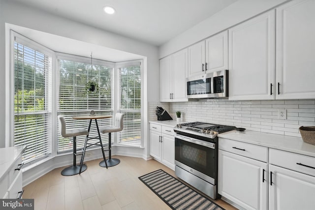 47686 Sandbank Sq, Sterling, VA 20165 - kitchen featuring stainless steel appliances, tasteful backsplash, white cabinetry, and recessed lighting