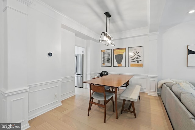 47686 Sandbank Sq, Sterling, VA 20165 - dining space with a decorative wall, light wood-type flooring, crown molding, and a wainscoted wall