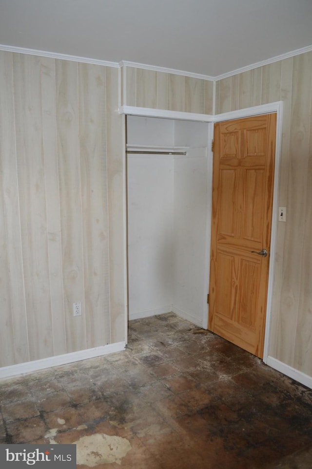 116 Queen Lily Rd, Levittown, PA 19057 - unfurnished bedroom featuring a closet, baseboards, and wooden walls