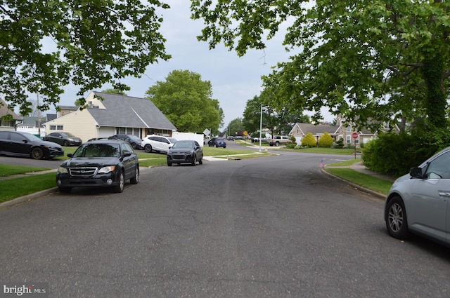 116 Queen Lily Rd, Levittown, PA 19057 - view of asphalt street featuring sidewalks, curbs, a residential view, and street lights