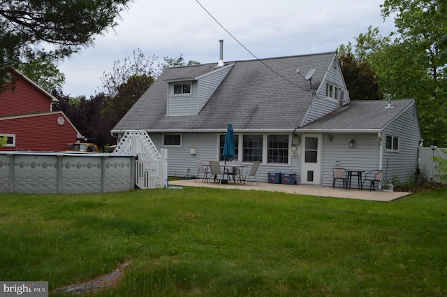 116 Queen Lily Rd, Levittown, PA 19057 - back of property with a yard, a shingled roof, an outdoor pool, and a patio area