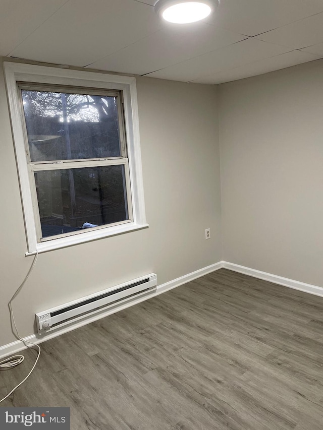 3816 Fairhaven Ave, Baltimore City, MD 21226 - empty room with a baseboard heating unit, wood finished floors, and baseboards