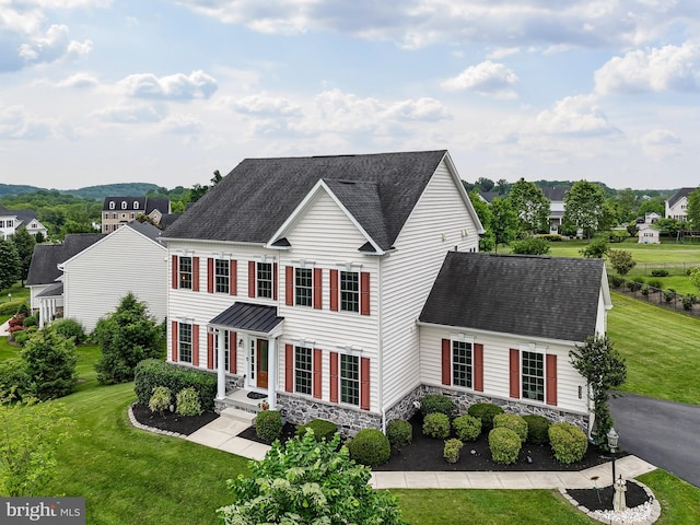 131 Pierce Ln, Kennett Square, PA 19348 - colonial-style house with a front yard, stone siding, and roof with shingles