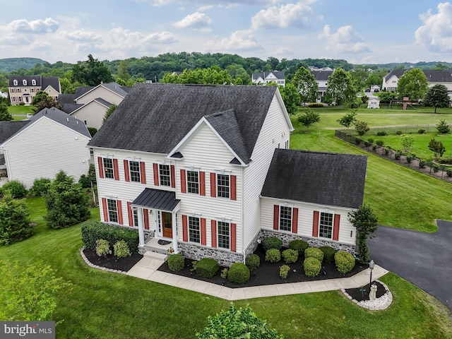 131 Pierce Ln, Kennett Square, PA 19348 - colonial home featuring roof with shingles, a front lawn, and a residential view