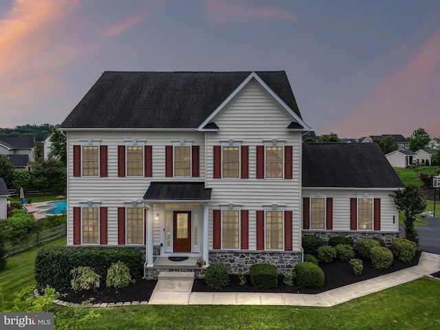 131 Pierce Ln, Kennett Square, PA 19348 - view of front of home featuring stone siding, a shingled roof, and a standing seam roof