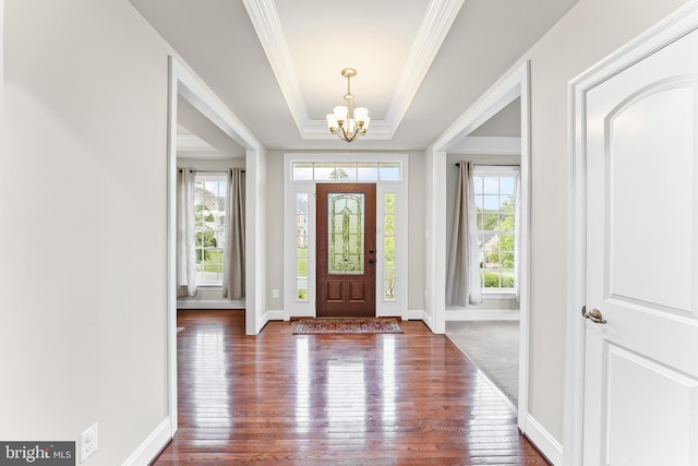 131 Pierce Ln, Kennett Square, PA 19348 - foyer entrance featuring a chandelier, wood-type flooring, crown molding, a raised ceiling, and baseboards