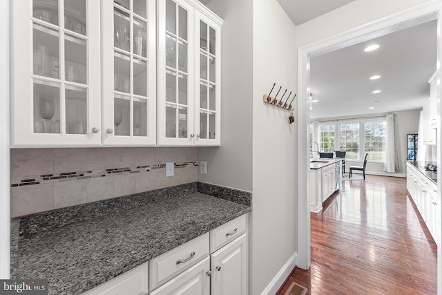131 Pierce Ln, Kennett Square, PA 19348 - kitchen featuring a sink, white cabinets, tasteful backsplash, glass insert cabinets, and wood finished floors