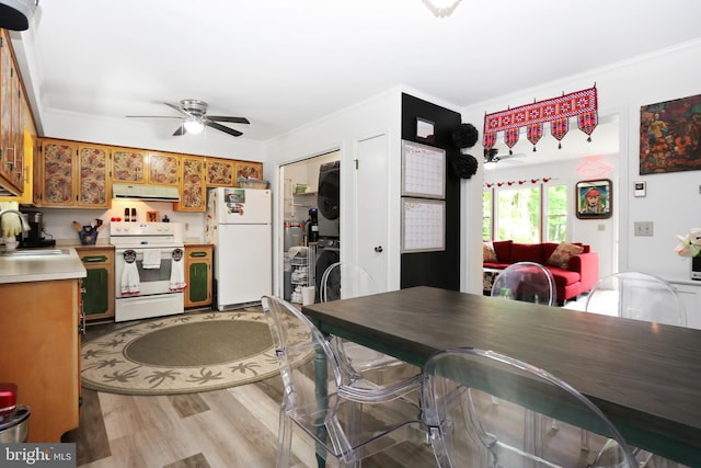 4233 Spire Ct, Snow Hill, MD 21863 - kitchen featuring white appliances, stacked washer and clothes dryer, range hood, a sink, and brown cabinets