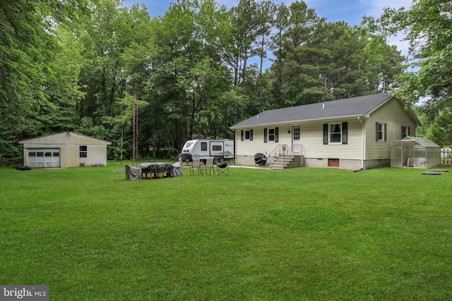 4233 Spire Ct, Snow Hill, MD 21863 - rear view of house with an outdoor structure, an exterior structure, a lawn, and a shingled roof