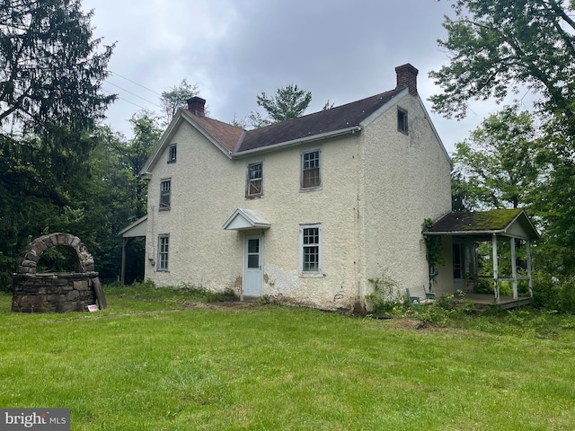 2806 Morris Rd, Lansdale, PA 19446 - back of property featuring a chimney, a lawn, and stucco siding