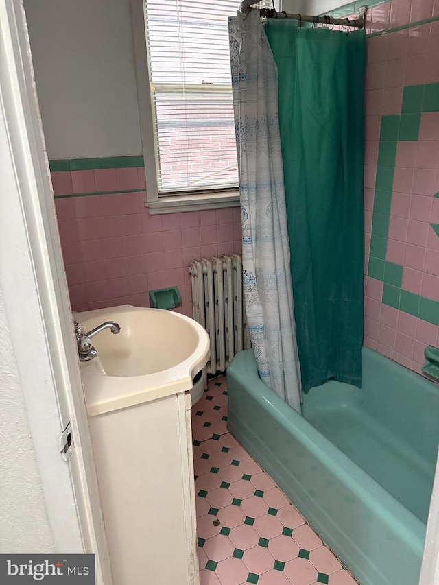 2441 S Hutchinson St, Philadelphia, PA 19148 - bathroom featuring radiator, tile patterned floors, tile walls, shower / bathtub combination with curtain, and vanity