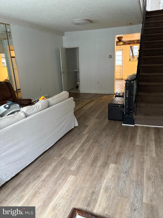 2441 S Hutchinson St, Philadelphia, PA 19148 - living area with wood finished floors, stairs, and a textured ceiling