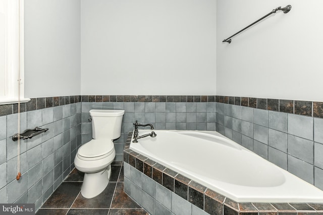 8358 Alvord St, Mclean, VA 22102 - bathroom with a bath, toilet, tile walls, and a wainscoted wall