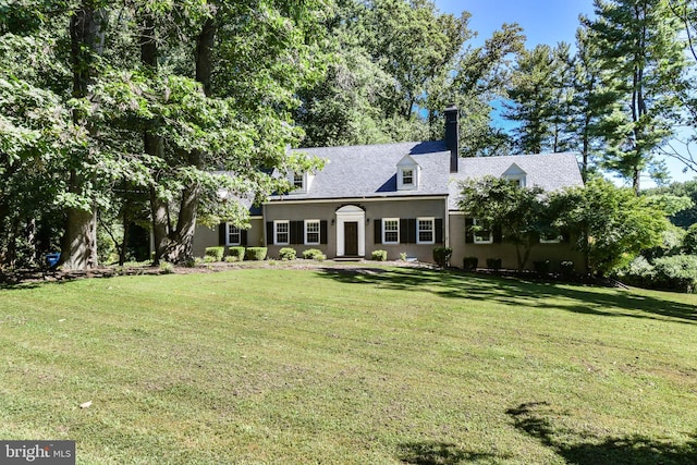8358 Alvord St, Mclean, VA 22102 - new england style home with a front lawn, stucco siding, and a chimney