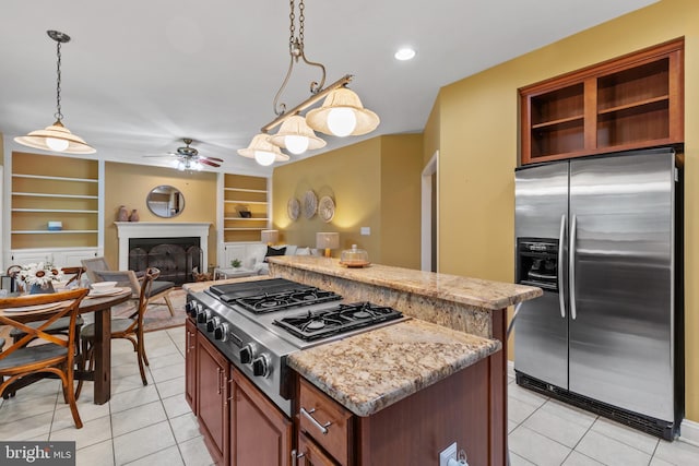 2121 Chaucer Way, Woodstock, MD 21163 - kitchen featuring appliances with stainless steel finishes, ceiling fan, light tile patterned floors, a kitchen island, and built in shelves