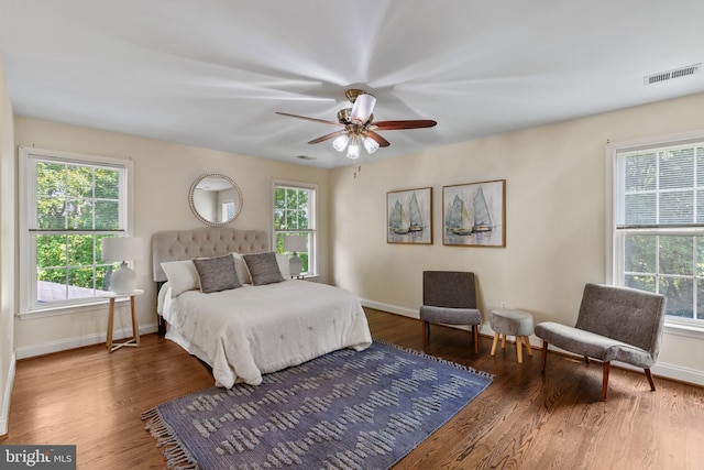 2121 Chaucer Way, Woodstock, MD 21163 - bedroom with multiple windows, wood finished floors, and baseboards