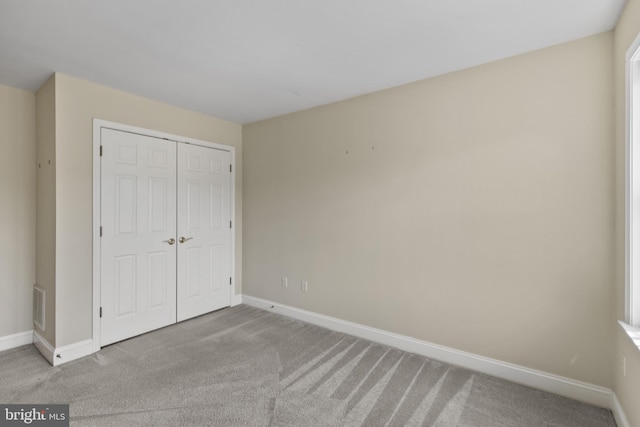 2121 Chaucer Way, Woodstock, MD 21163 - unfurnished bedroom featuring carpet, baseboards, and a closet