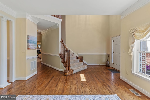 2121 Chaucer Way, Woodstock, MD 21163 - entrance foyer with decorative columns, ornamental molding, wood finished floors, baseboards, and stairs