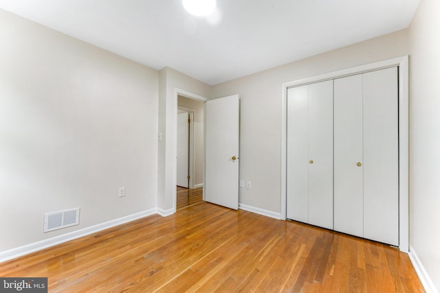 5200 Shires Ct, Clinton, MD 20735 - unfurnished bedroom with light wood-style flooring, baseboards, and a closet