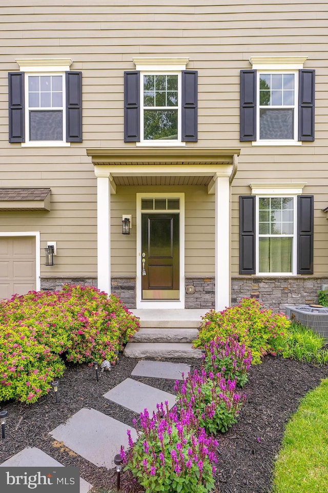 311 Ironstone Ln, Elverson, PA 19520 - property entrance with stone siding and central AC unit
