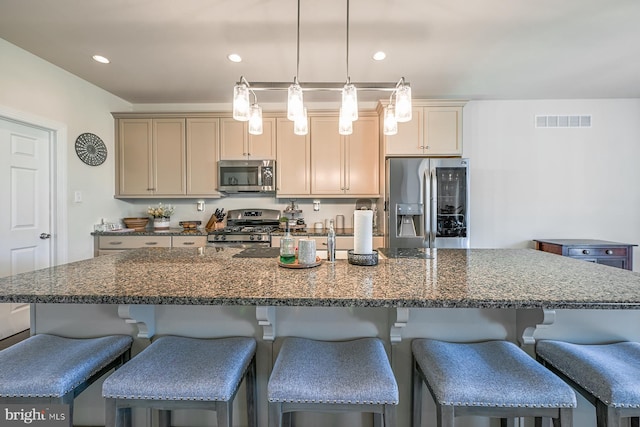 311 Ironstone Ln, Elverson, PA 19520 - kitchen featuring stainless steel appliances, a kitchen bar, a center island with sink, hanging light fixtures, and recessed lighting