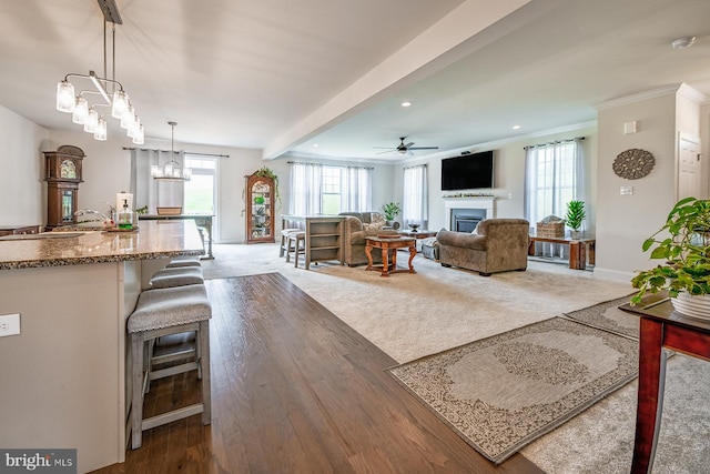 311 Ironstone Ln, Elverson, PA 19520 - carpeted living area featuring baseboards, a fireplace, recessed lighting, ceiling fan, and a chandelier