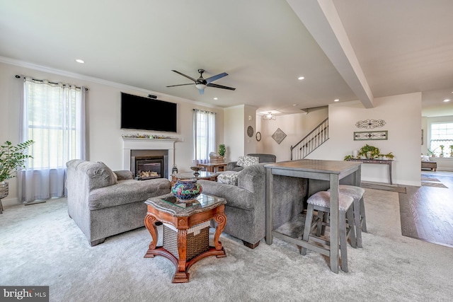 311 Ironstone Ln, Elverson, PA 19520 - living room featuring stairs, a glass covered fireplace, crown molding, ceiling fan, and recessed lighting