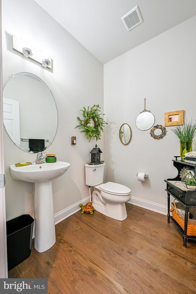 311 Ironstone Ln, Elverson, PA 19520 - bathroom with baseboards, wood finished floors, toilet, and a sink