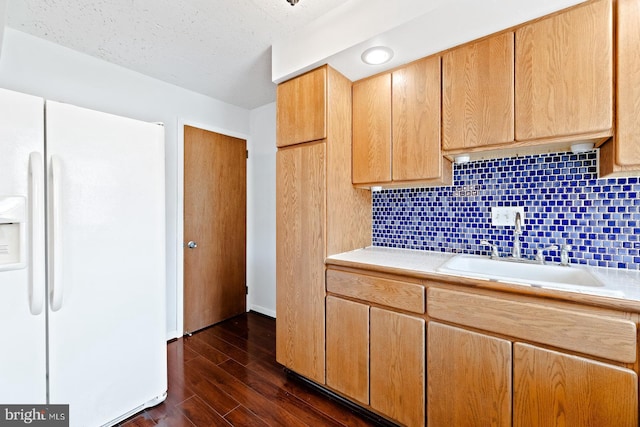7155 Erdrick St, Philadelphia, PA 19135 - kitchen with white fridge with ice dispenser, a sink, tasteful backsplash, dark wood-style floors, and baseboards