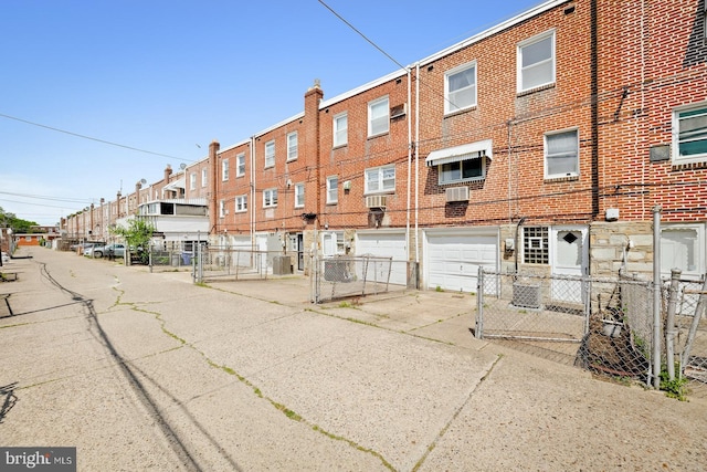 7155 Erdrick St, Philadelphia, PA 19135 - view of building exterior featuring driveway, a garage, and a residential view